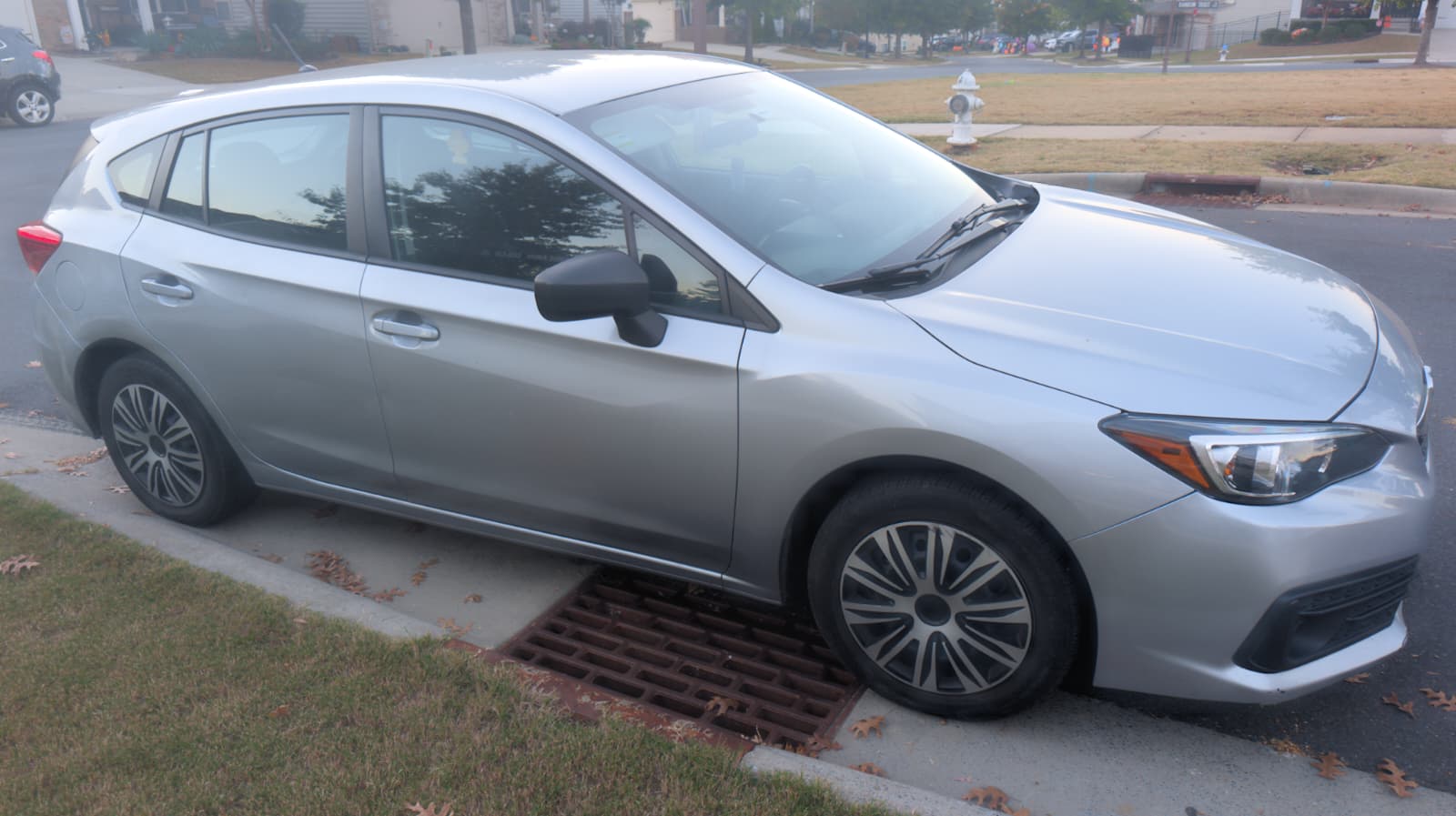 Silver Impreza hatchback passenger-side profile